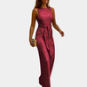 model draagt elegante jumpsuit met glitters glitter jumpsuit met open rug en riem band ideaal voor uitgaan feest jumpsuit